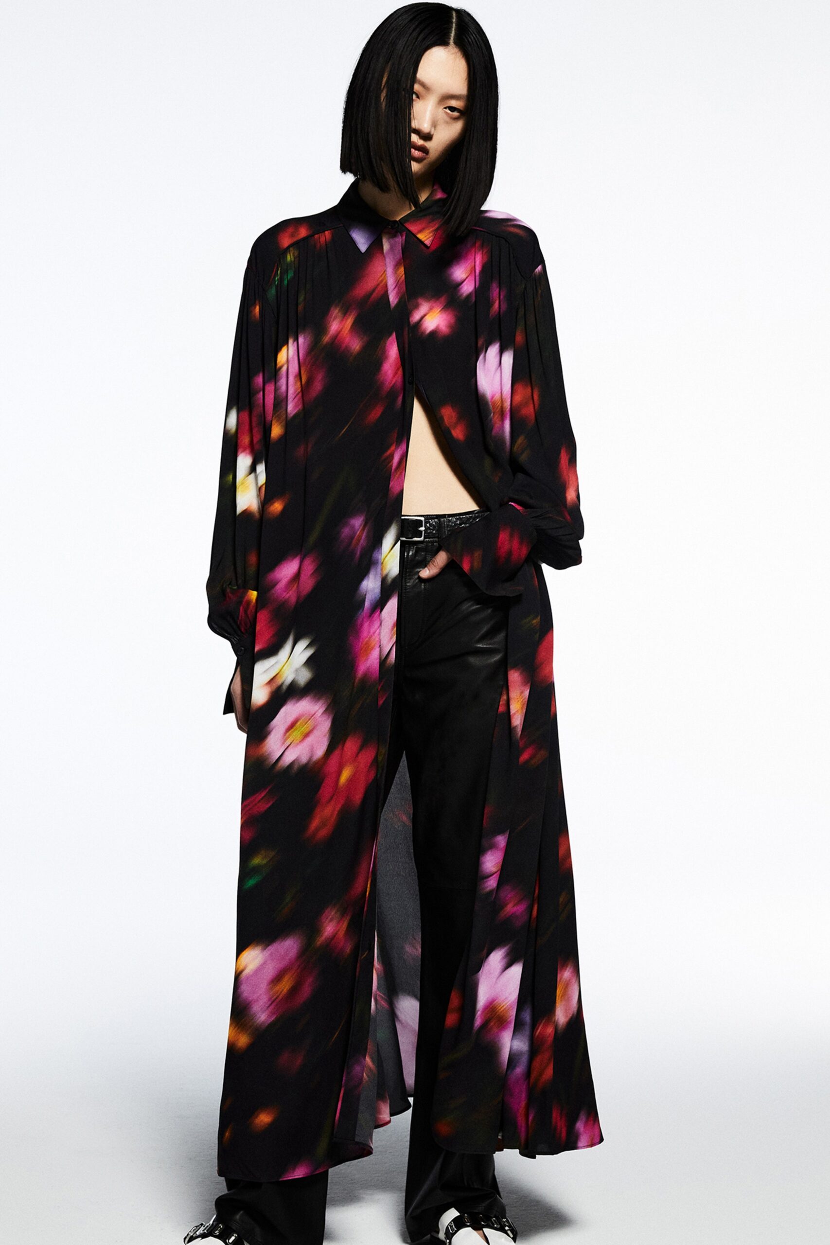 A relaxed black silk dress with long sleeves, a collared neckline, and floral design.