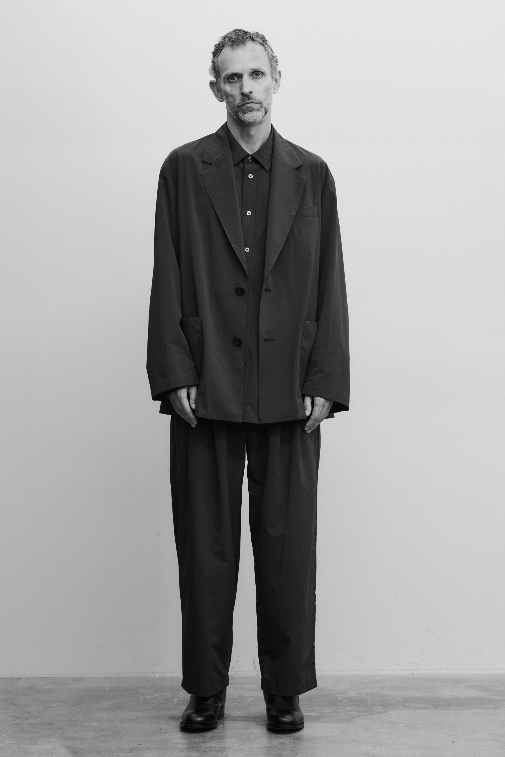 An oversized black suit with a buttoned jacket and loose-fitting trousers.