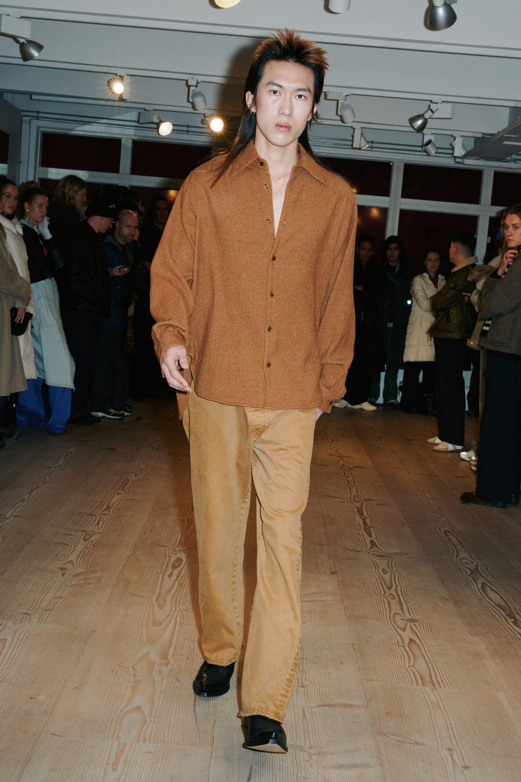 brown relaxed shirt and beige pants