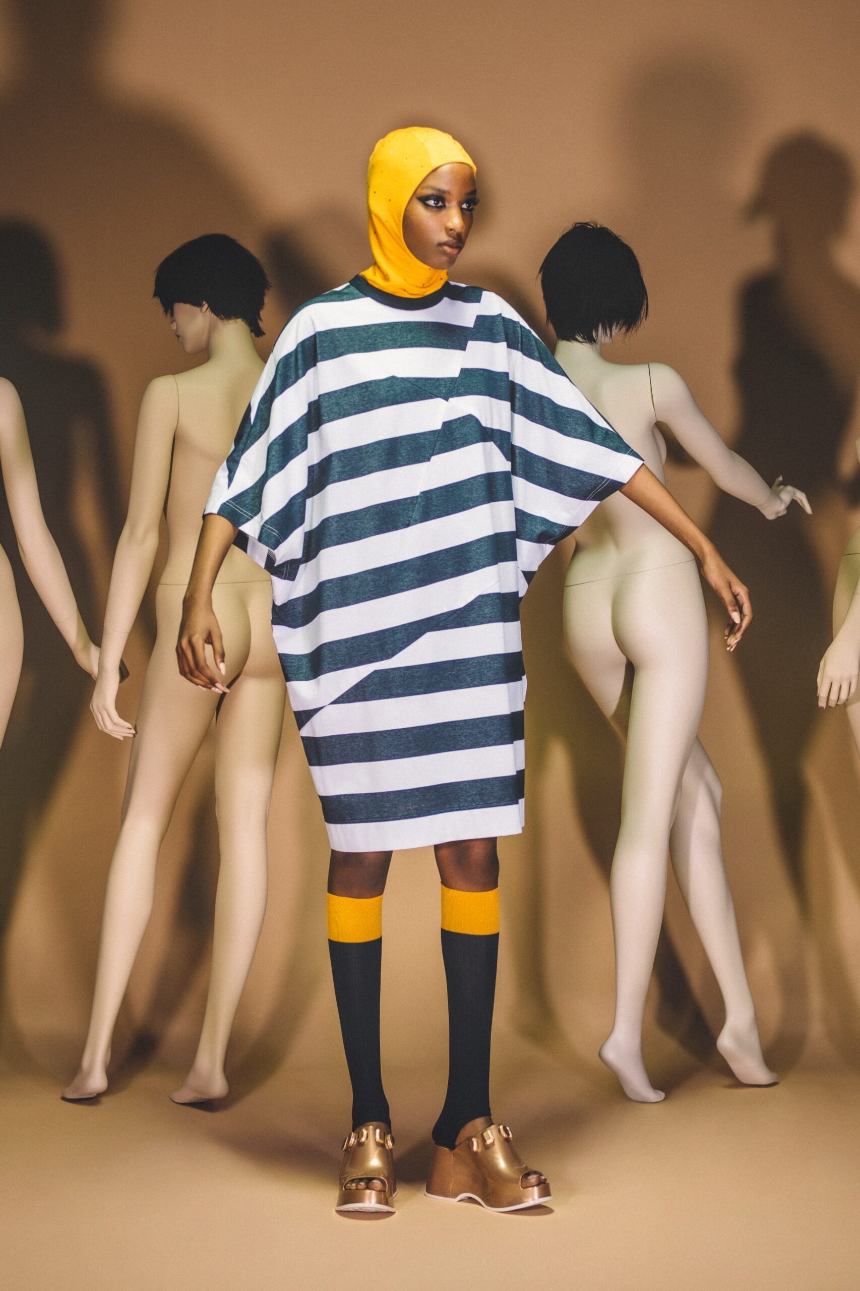 An oversized white and blue striped dress with a collared neckline and short sleeves.