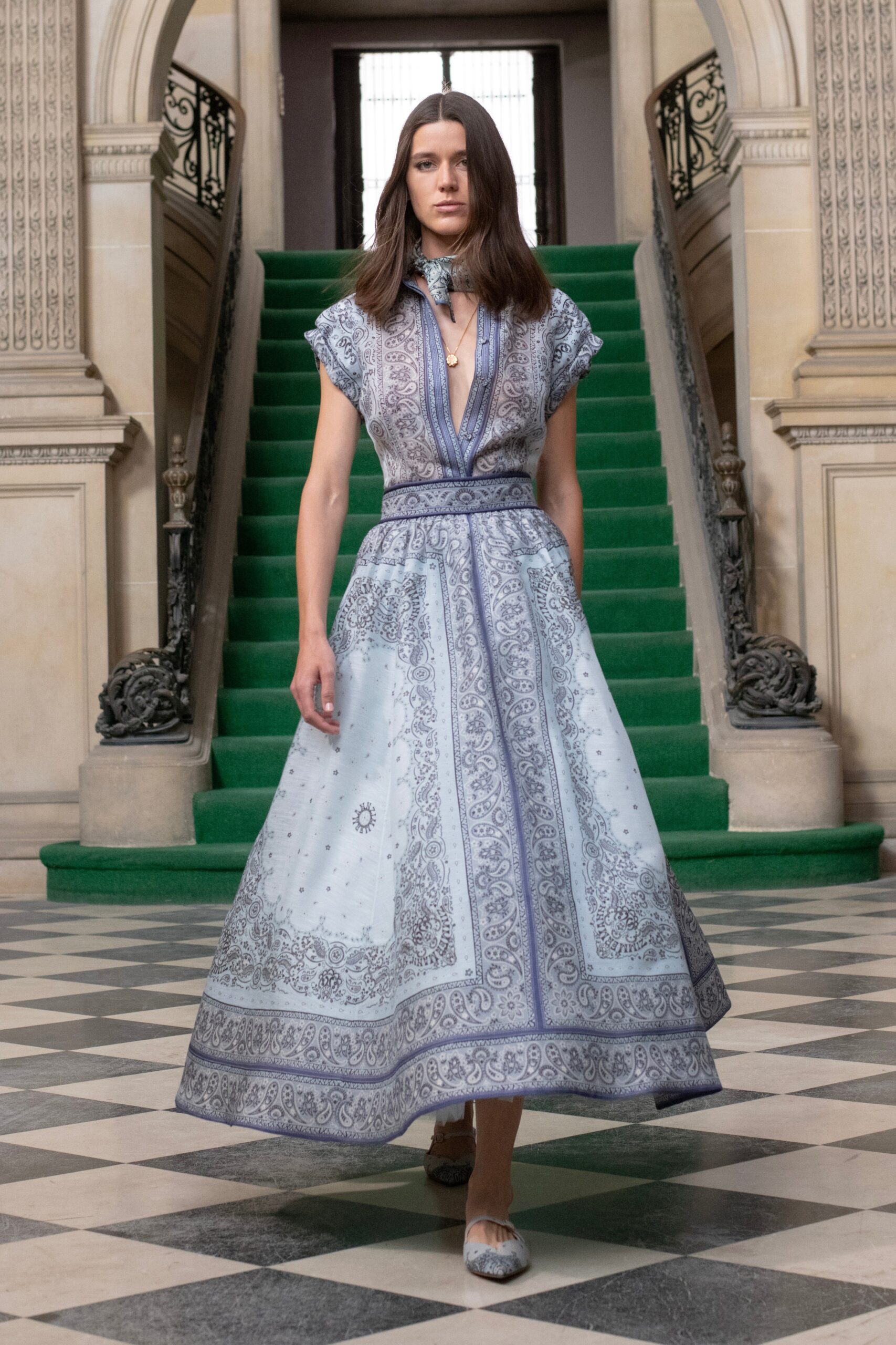 A relaxed blue silk dress with short sleeves, a V-neckline, and a tiered design.