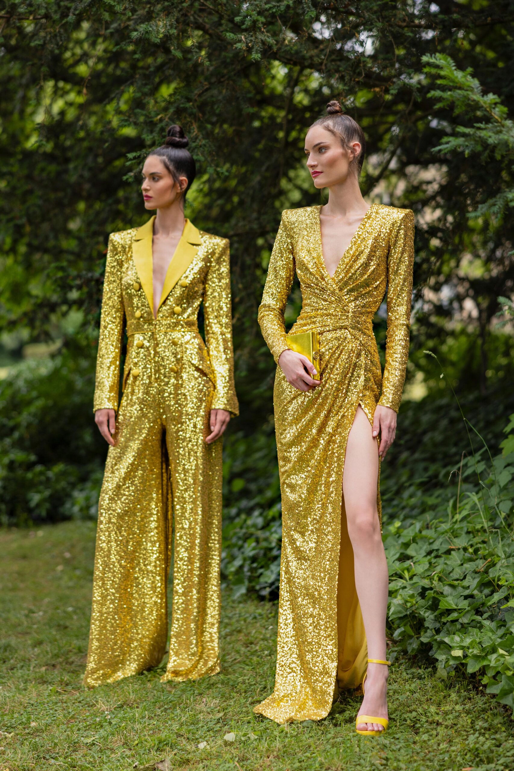 A fitted gold sequin gown with long sleeves, a V-neckline, and a thigh-high slit.