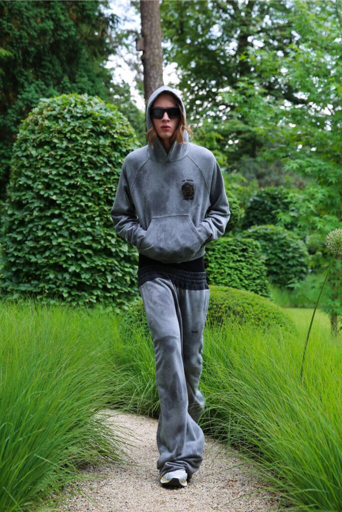 A relaxed gray cotton hoodie with long sleeves paired with matching pants, featuring a zippered detail.