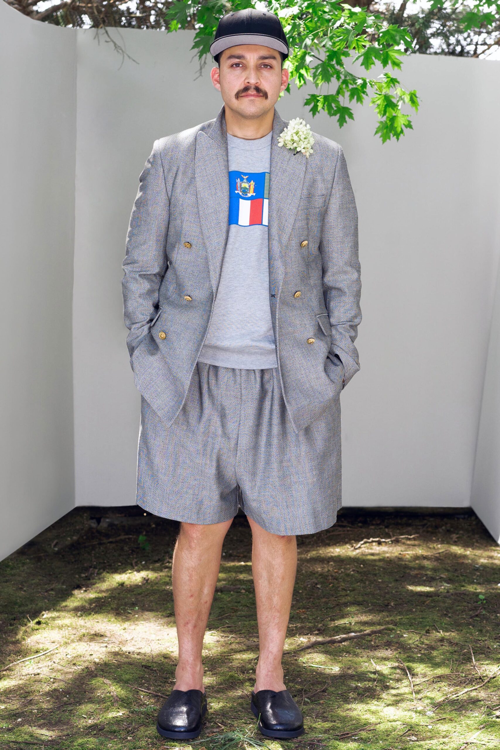 A relaxed gray cotton blazer paired with matching shorts featuring a buttoned design.