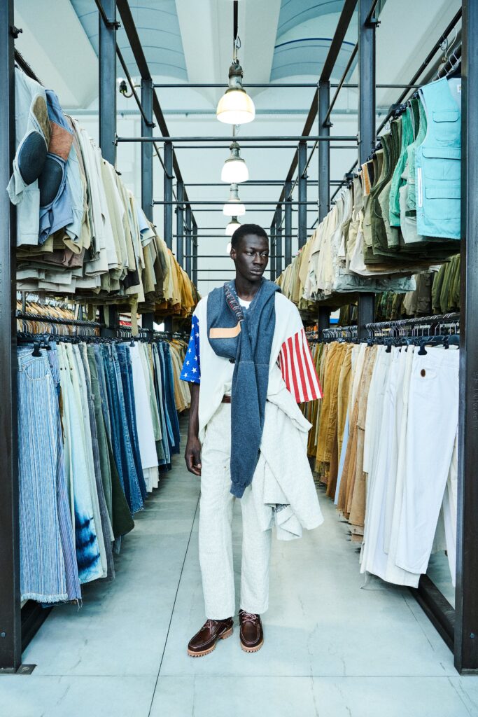 A relaxed white striped short-sleeve shirt paired with beige pants, creating a casual yet stylish look.