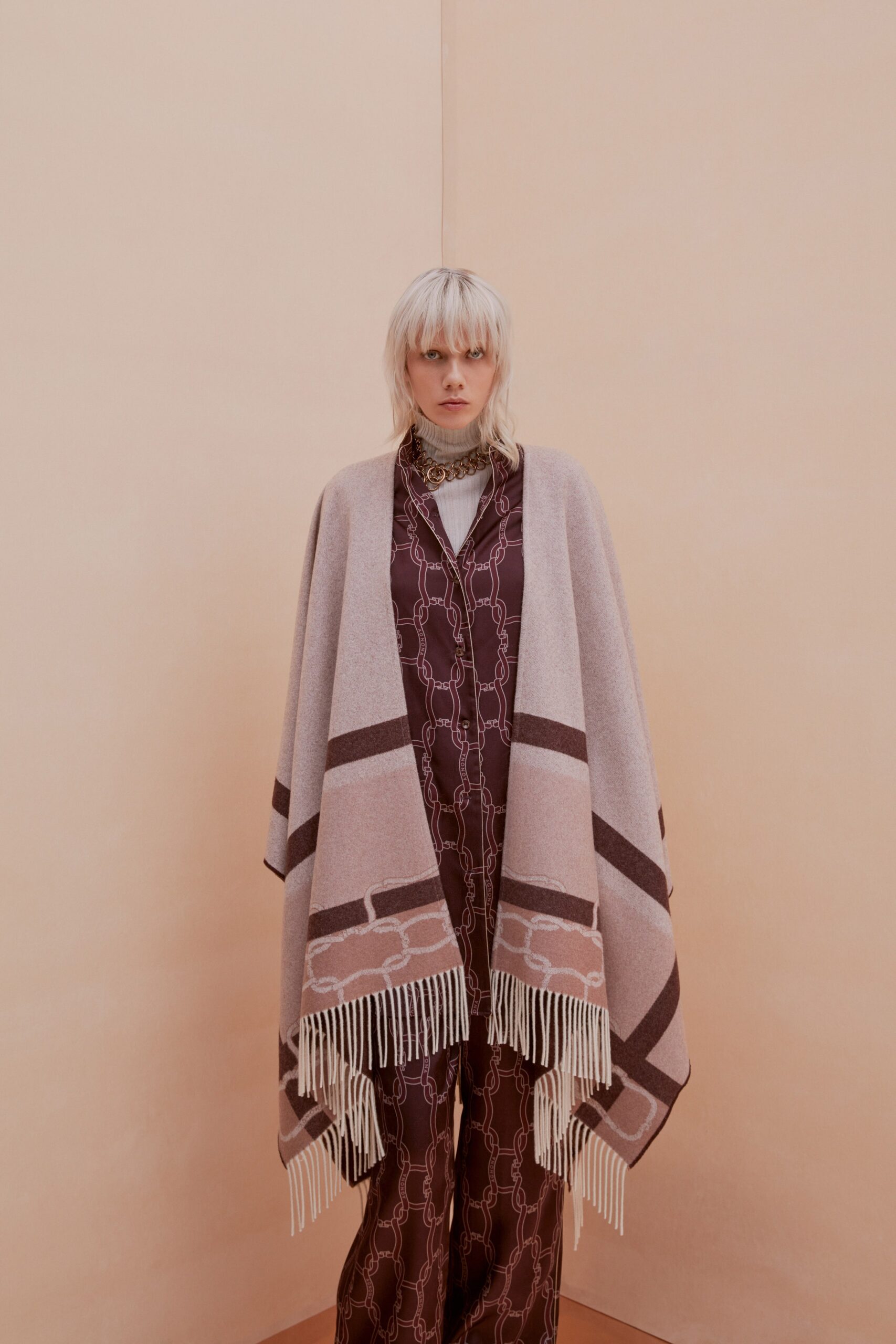 beige wool poncho and purple silk jumpsuit