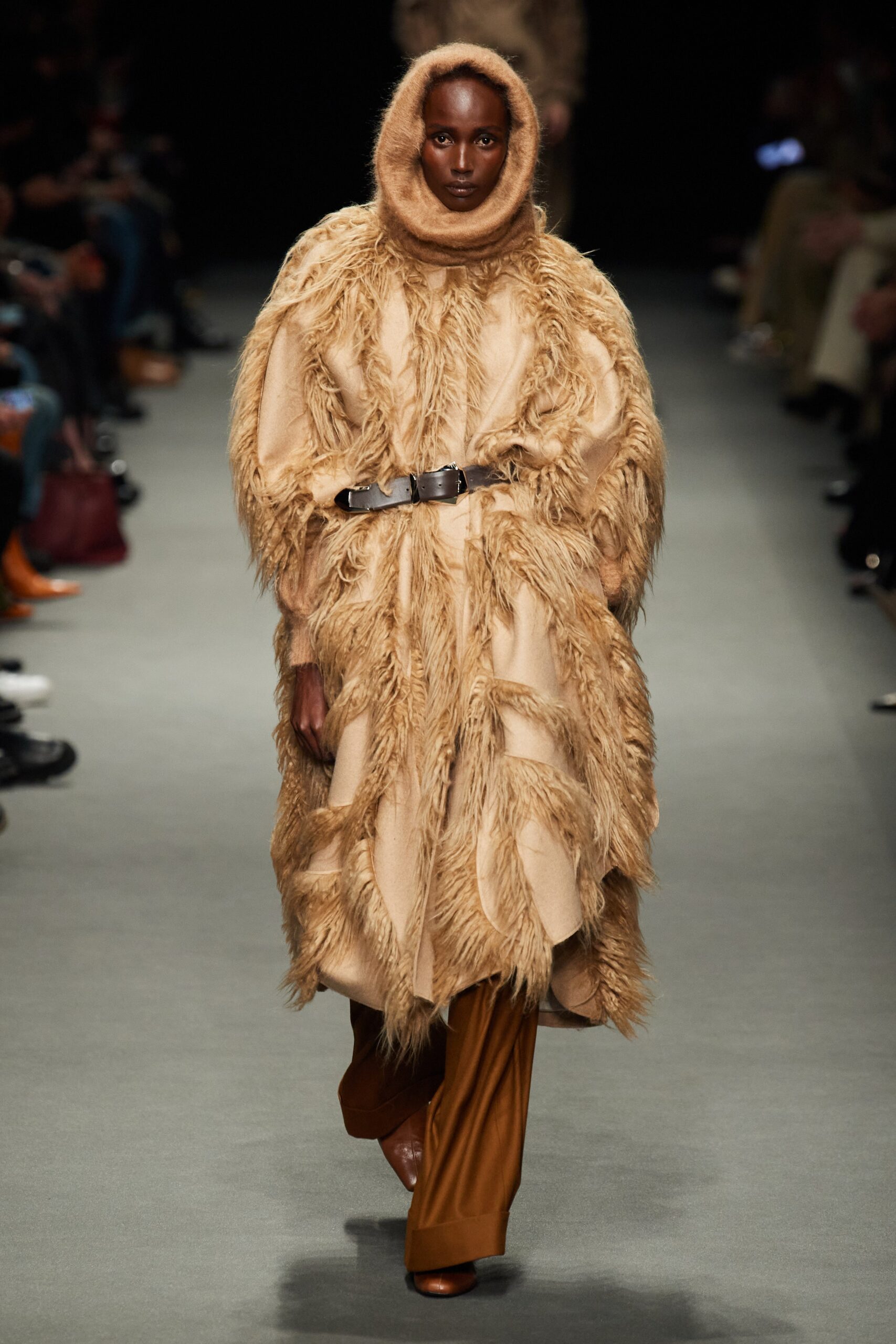 beige fur cape with brown pants