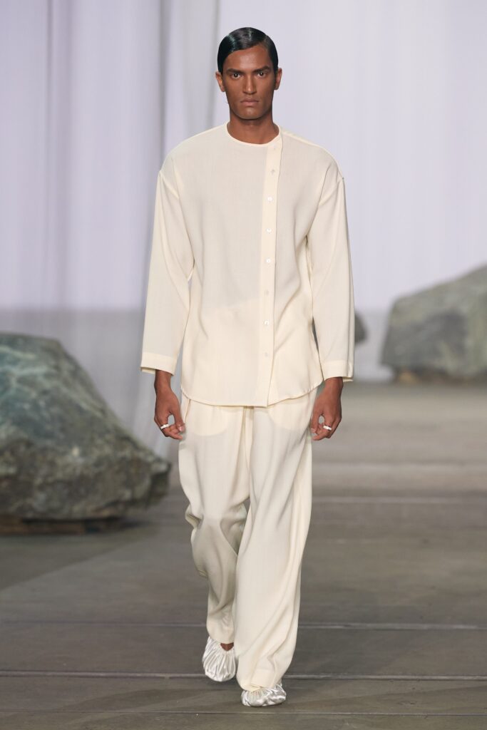 A relaxed white long-sleeve shirt with a collar, paired with matching pants.