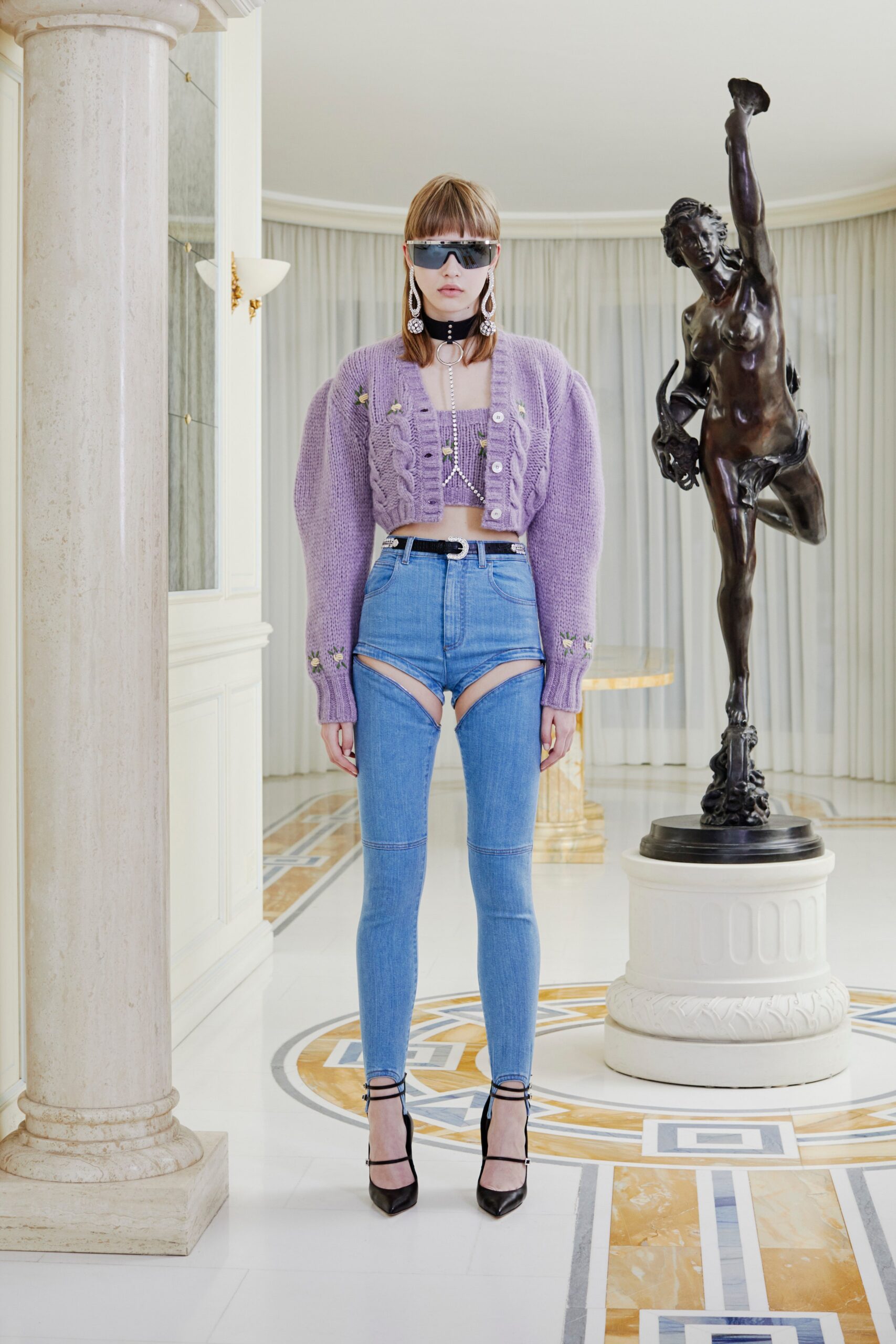 purple fitted sweater and blue jeans