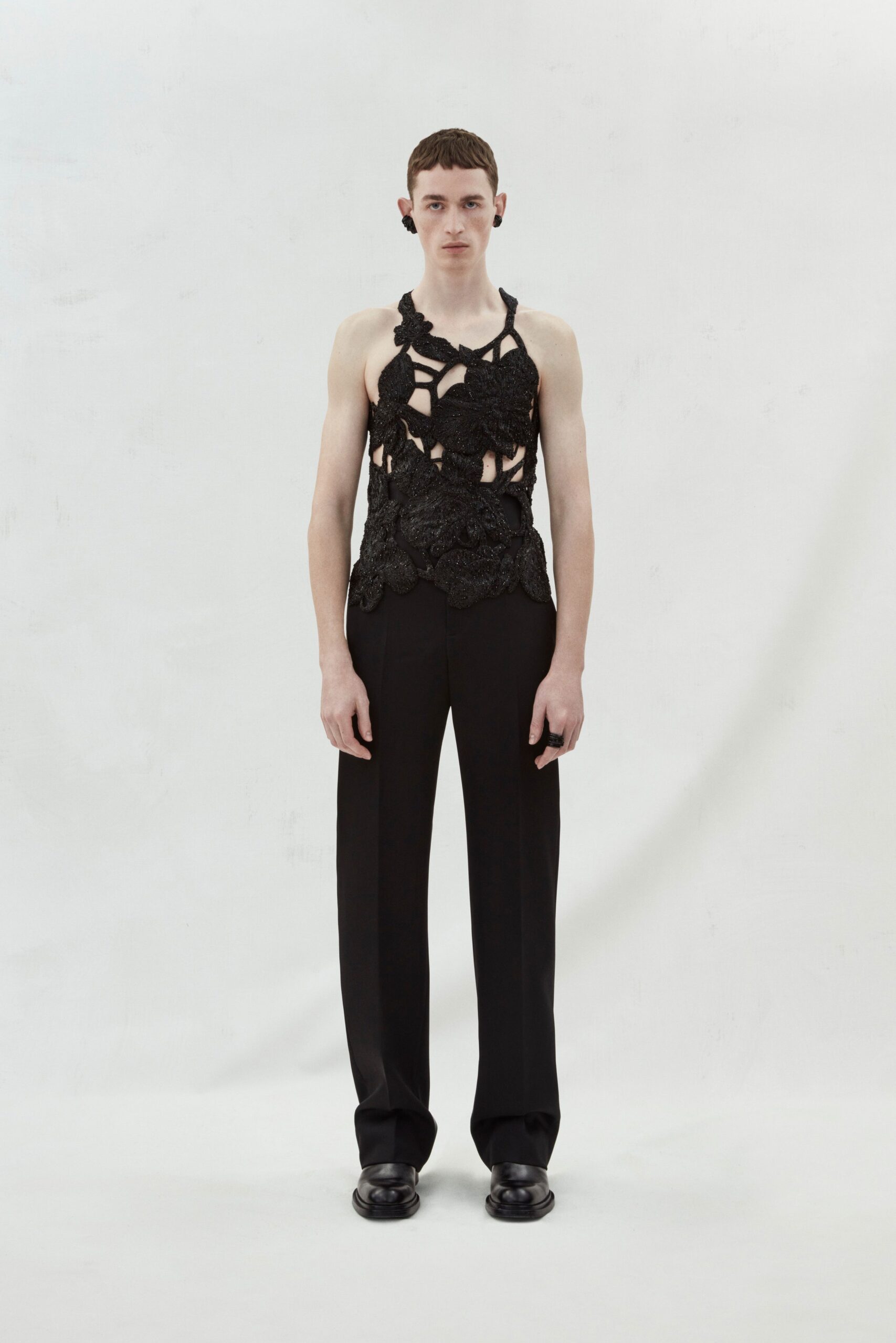 black lace top and tailored pants