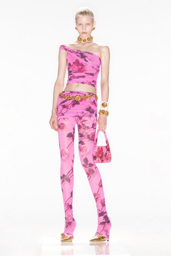 A fitted pink floral sleeveless top paired with matching leggings, creating a vibrant and stylish look.