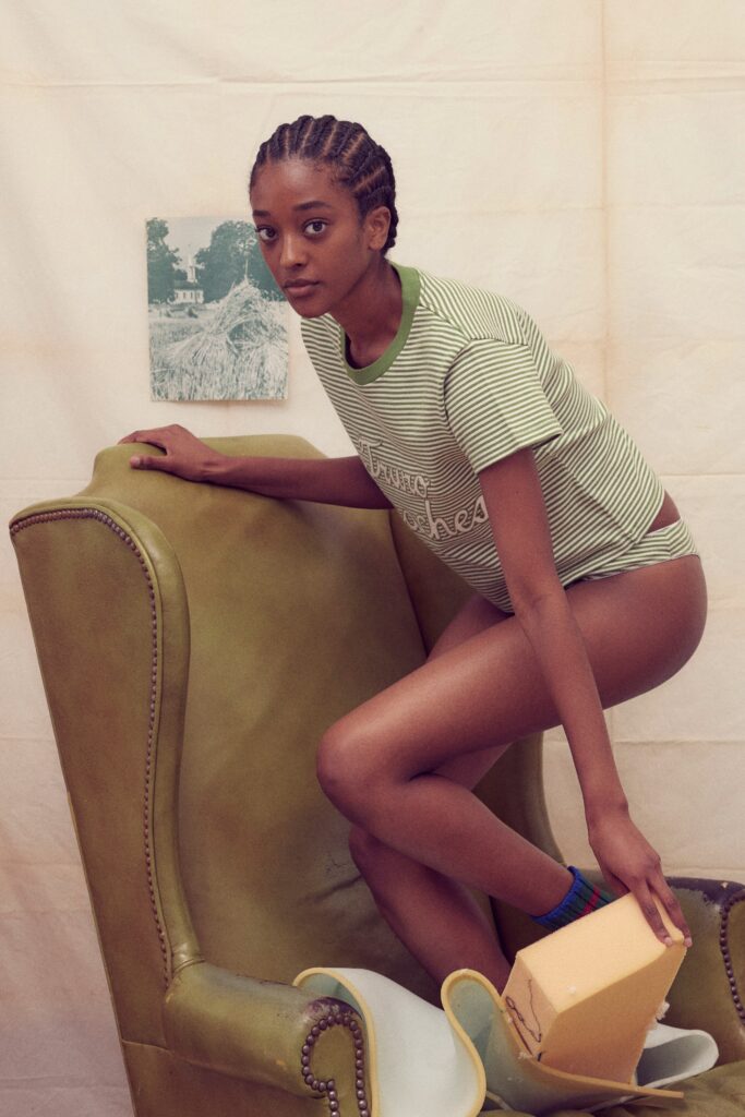 A fitted green and white striped t-shirt paired with shorts, featuring a casual and comfortable look.