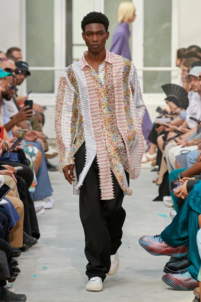 A relaxed multicolor printed shirt paired with black pants, featuring a layered design.