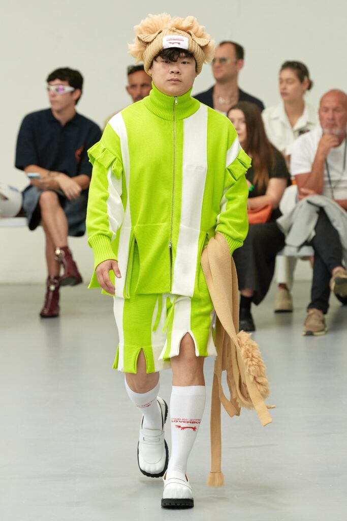 A relaxed green cotton outfit featuring a short-sleeve collared top and striped shorts.