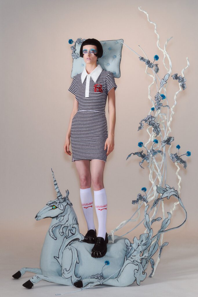 A fitted black and white striped dress with a collared neckline and short sleeves.