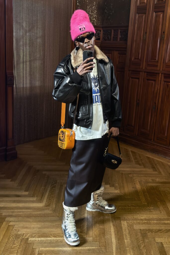 A relaxed black leather jacket paired with a layered asymmetric skirt.