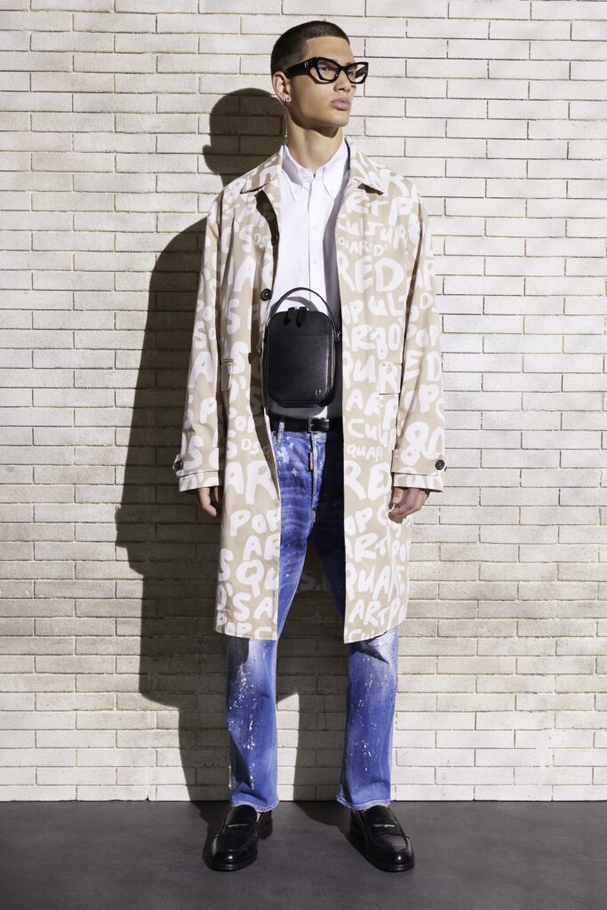A relaxed-fitting beige printed coat paired with straight-leg blue denim pants.