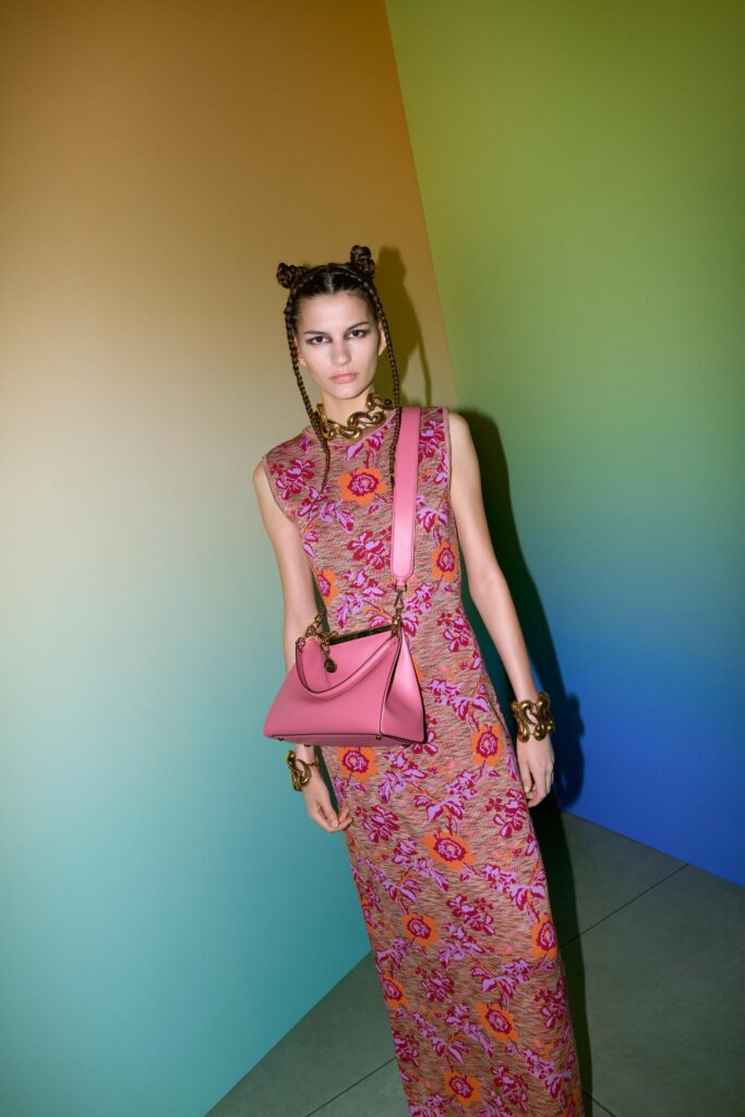 A fitted multicolor floral sleeveless dress with a high neckline.
