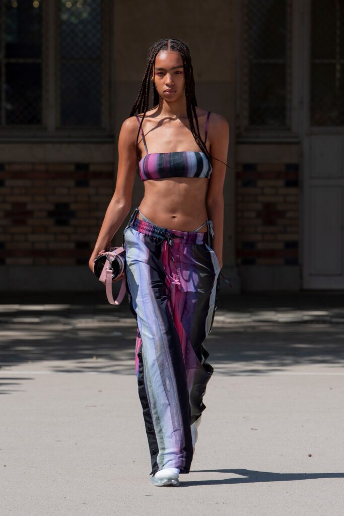 A fitted multicolor crop-top and high-waisted pants with a striped design.