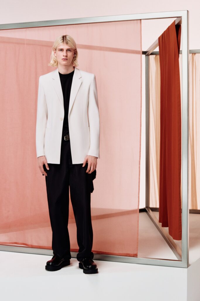 A relaxed white blazer paired with black straight-leg pants for a modern look.