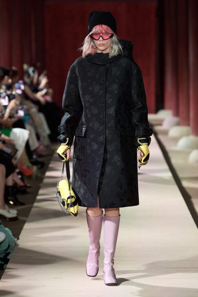 black relaxed coat with pink boots