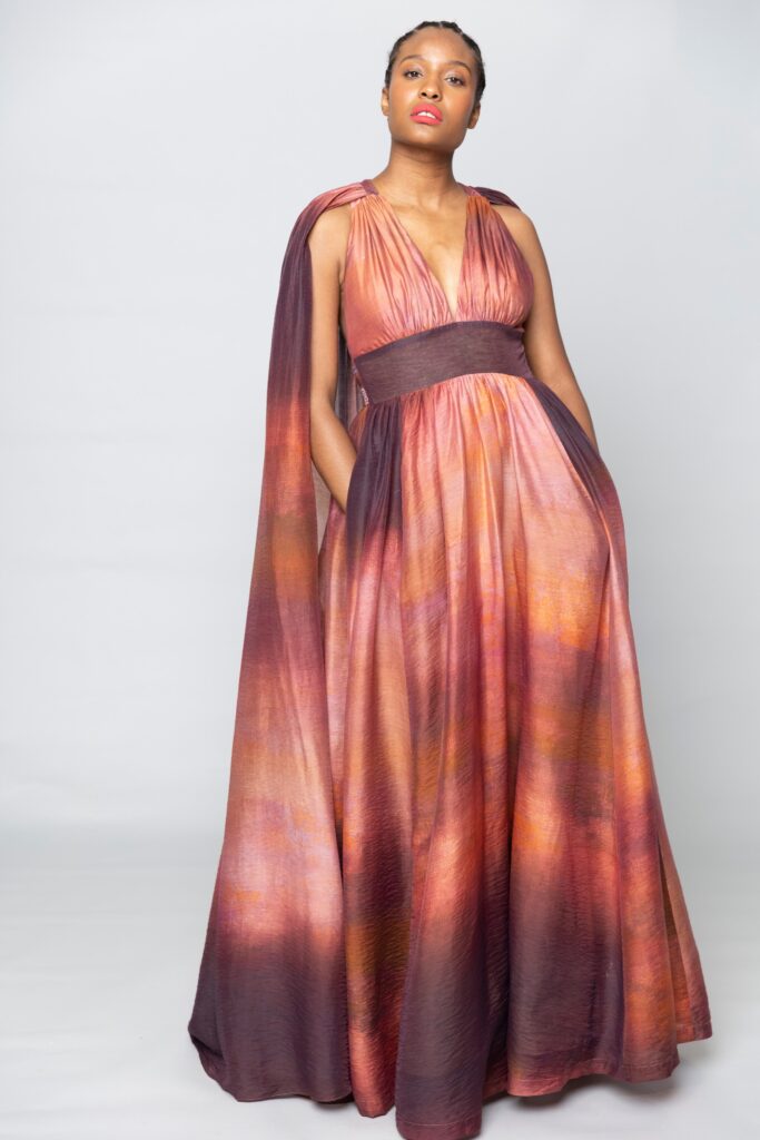 A fitted orange and purple silk gown with a sleeveless design and layered details.