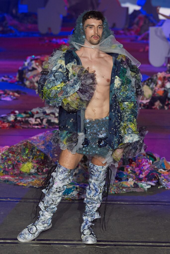 A relaxed blue tulle jacket with long sleeves and collared design, paired with multicolor shorts.