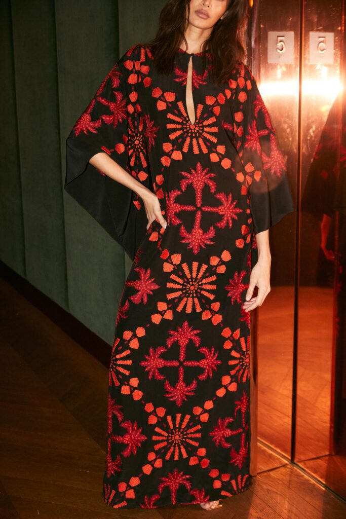 A relaxed black and red printed dress with a V-neckline and sleeveless design.