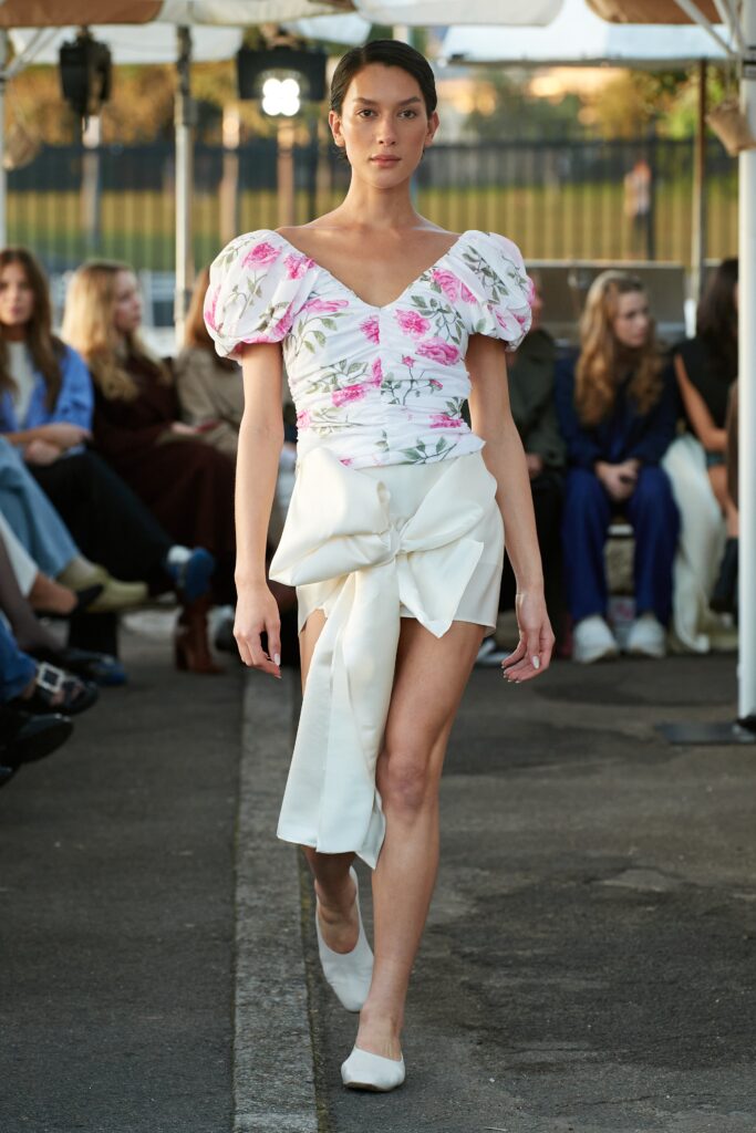A fitted floral dress with short sleeves and a V-neckline featuring an asymmetric design.
