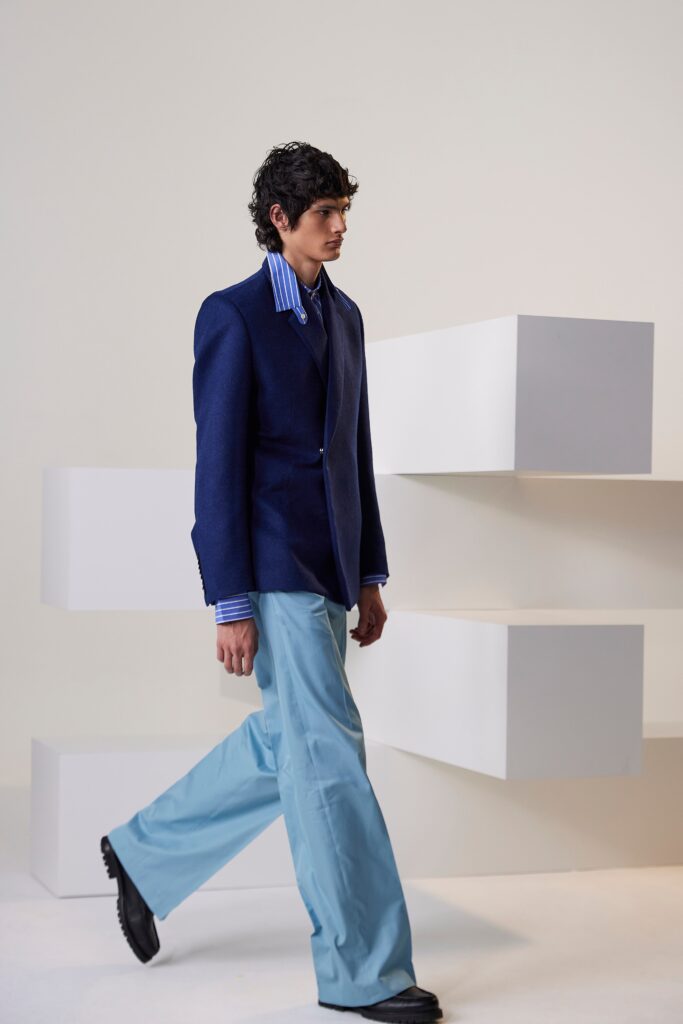 A fitted blue blazer paired with light blue straight-leg pants, featuring a collared design.