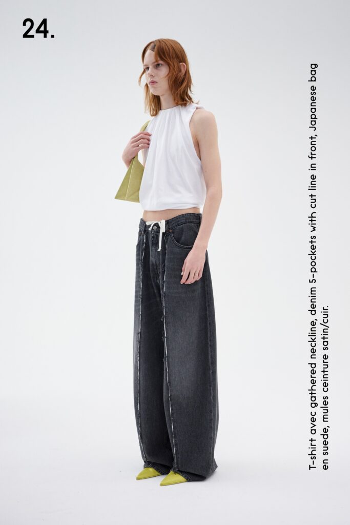 A relaxed white sleeveless top paired with wide-leg gray denim pants.