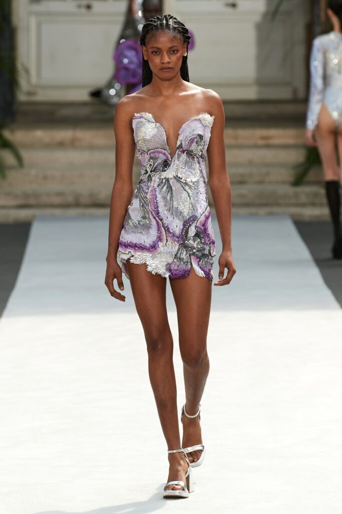 A fitted strapless purple silk dress with ruffled detailing for a dramatic look.