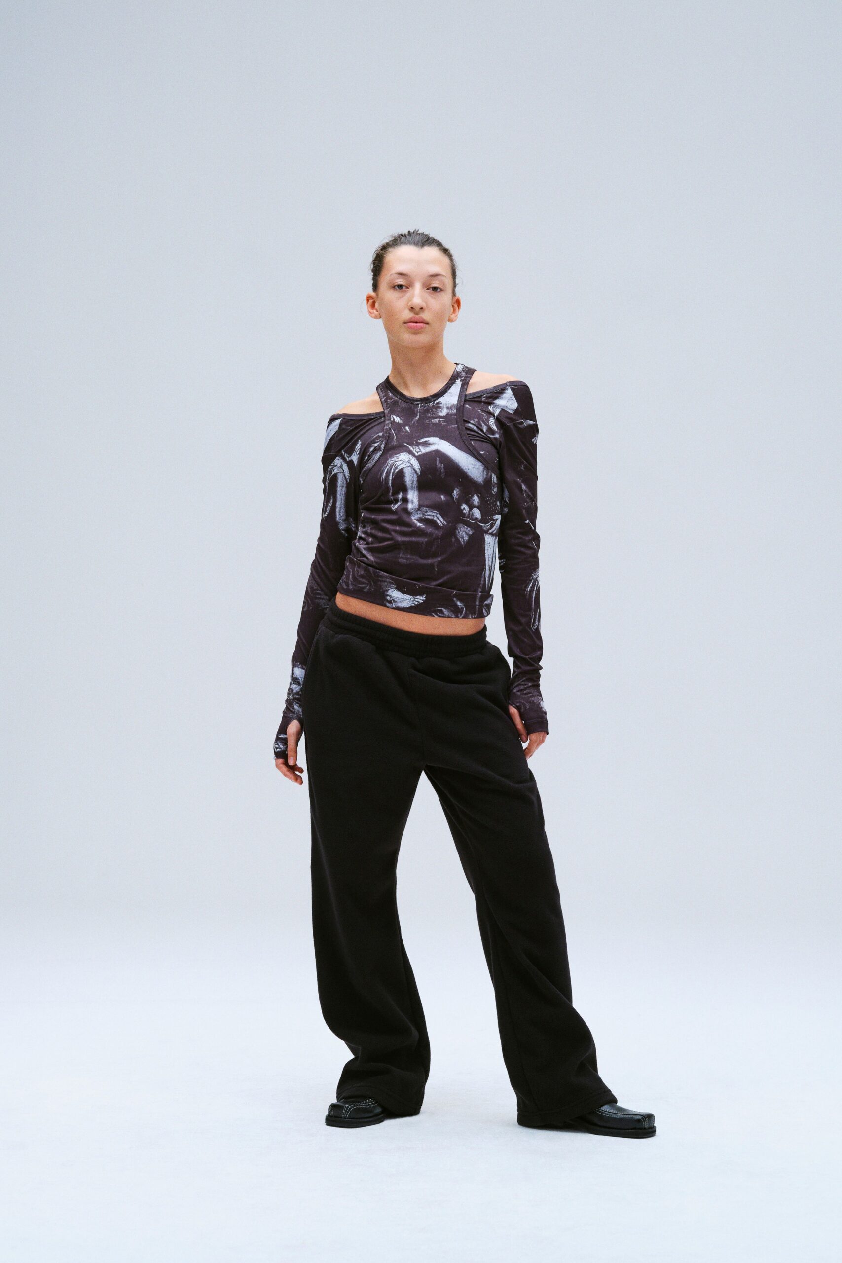 A relaxed black printed long-sleeve top paired with relaxed black pants.