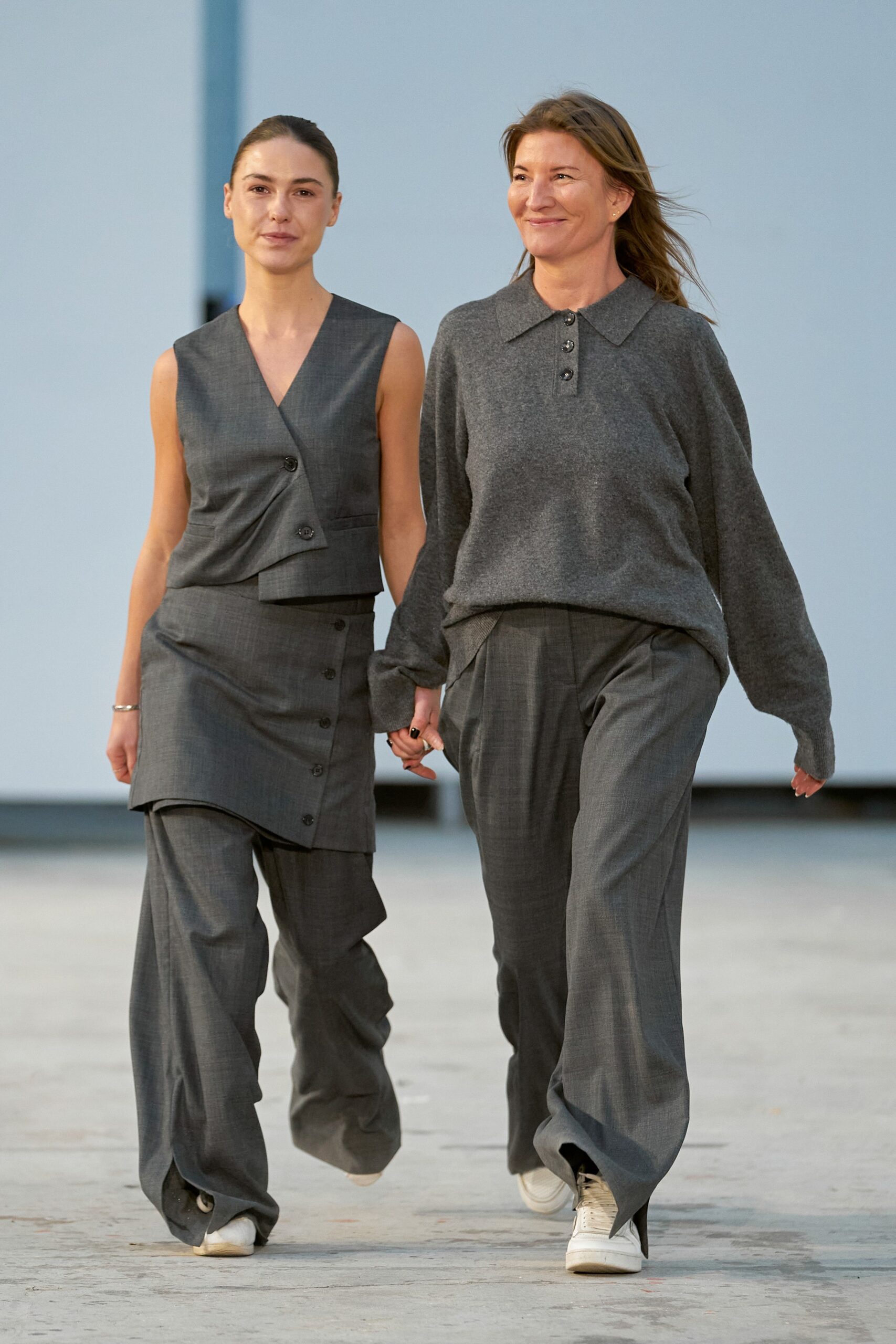 A relaxed gray sleeveless top with button details paired with wide-leg pants.