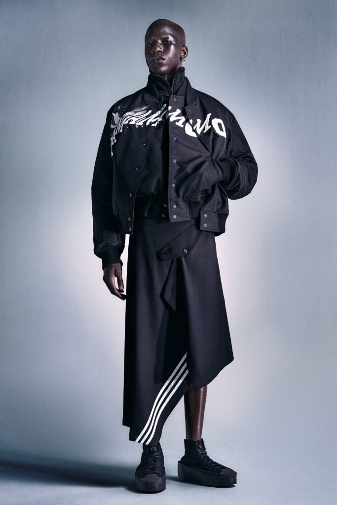 A relaxed black jacket with long sleeves and an asymmetric skirt.