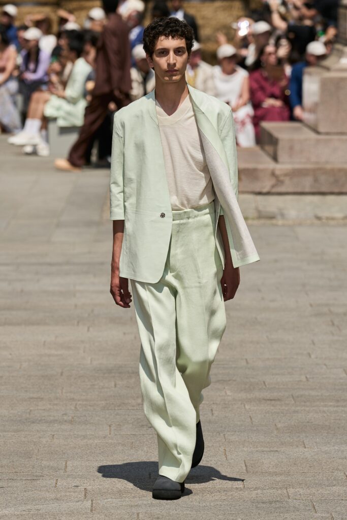 A relaxed green cotton suit with a long-sleeve collared shirt and straight-leg trousers.