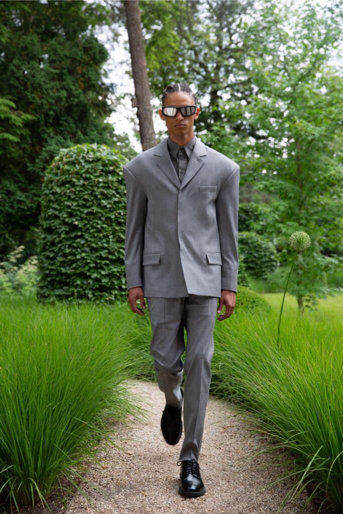 A structured gray suit with a collared long-sleeve shirt and buttoned details.