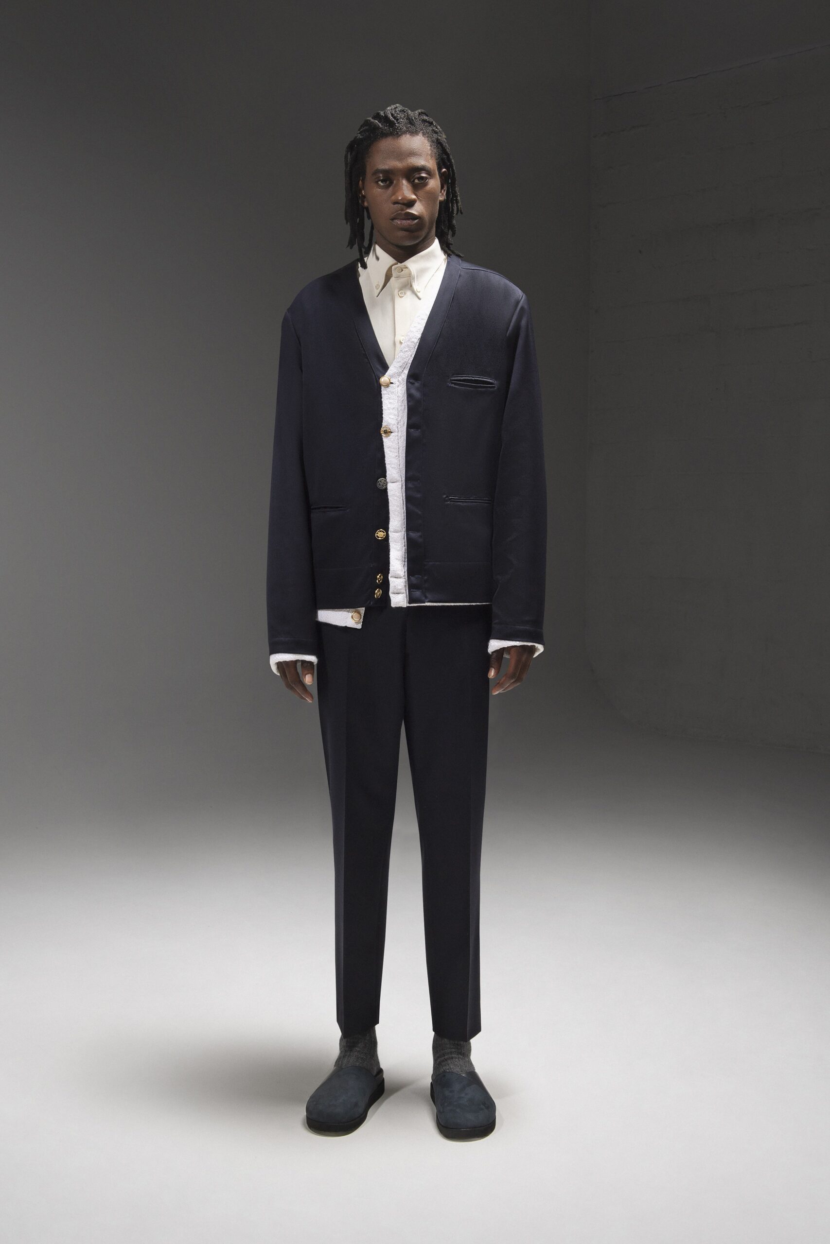 A relaxed navy cotton jacket with long sleeves and collared design paired with matching pants.