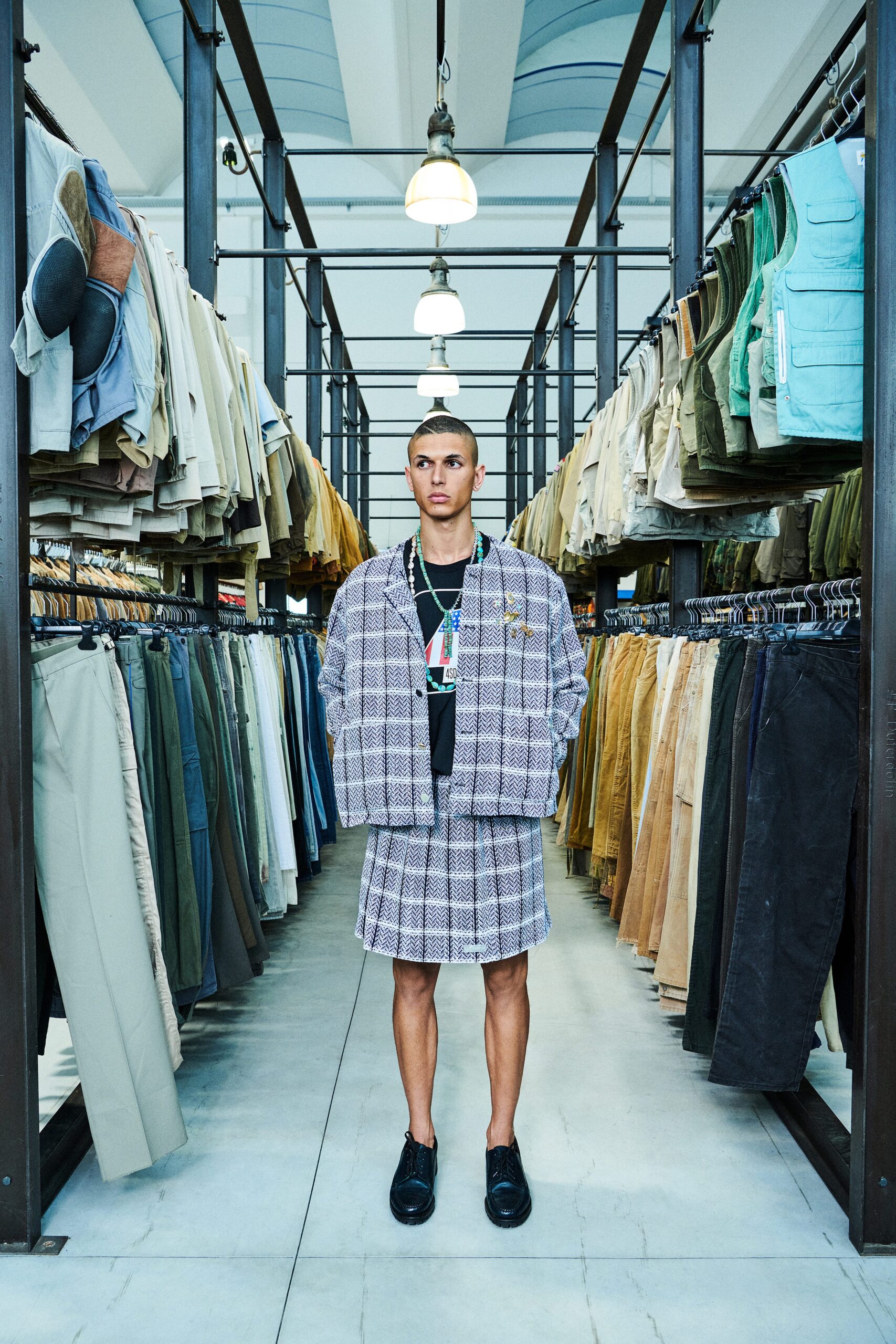 A relaxed gray checked jacket paired with a matching skirt, featuring a collared design.