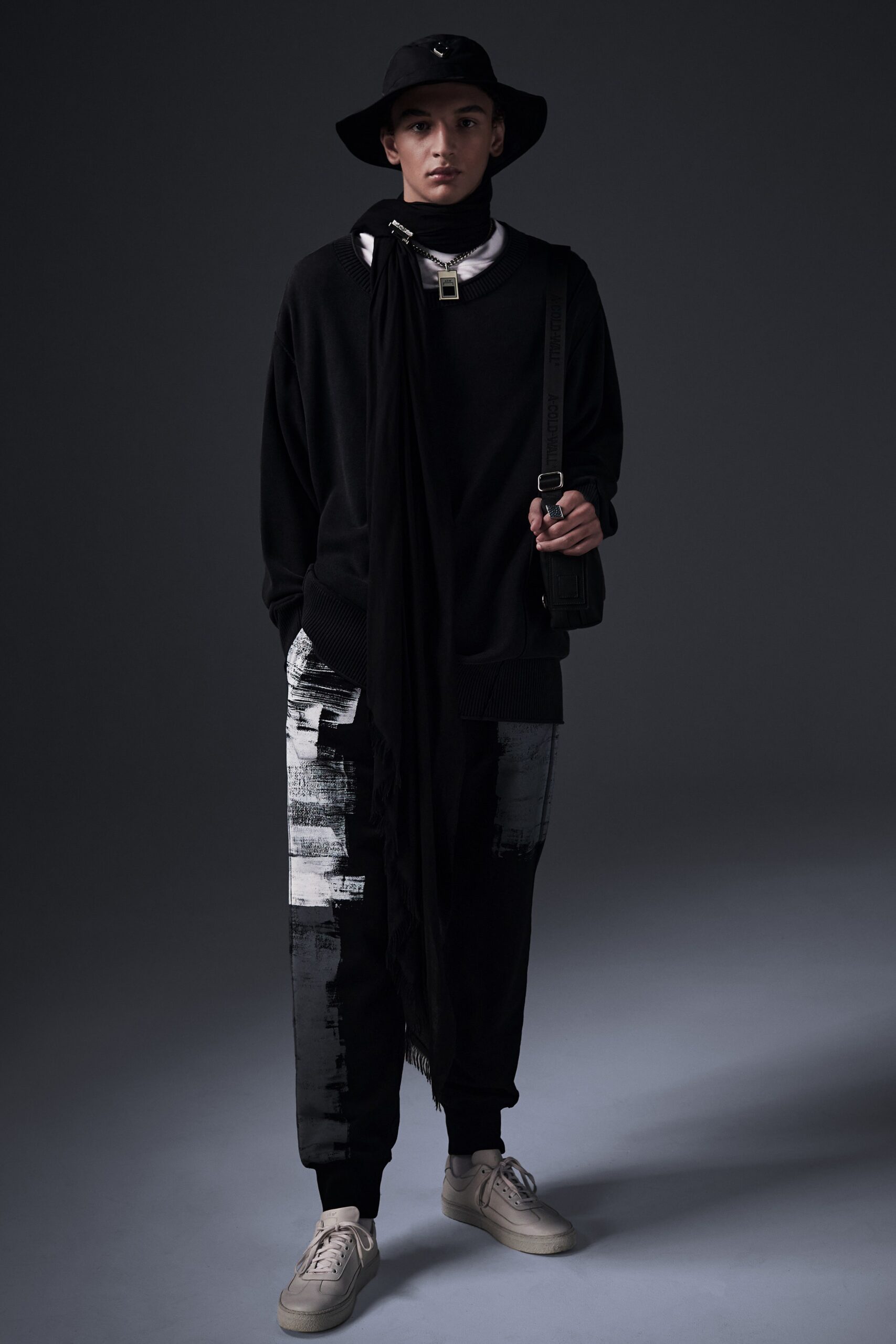 A relaxed black sweater with long sleeves paired with printed pants.
