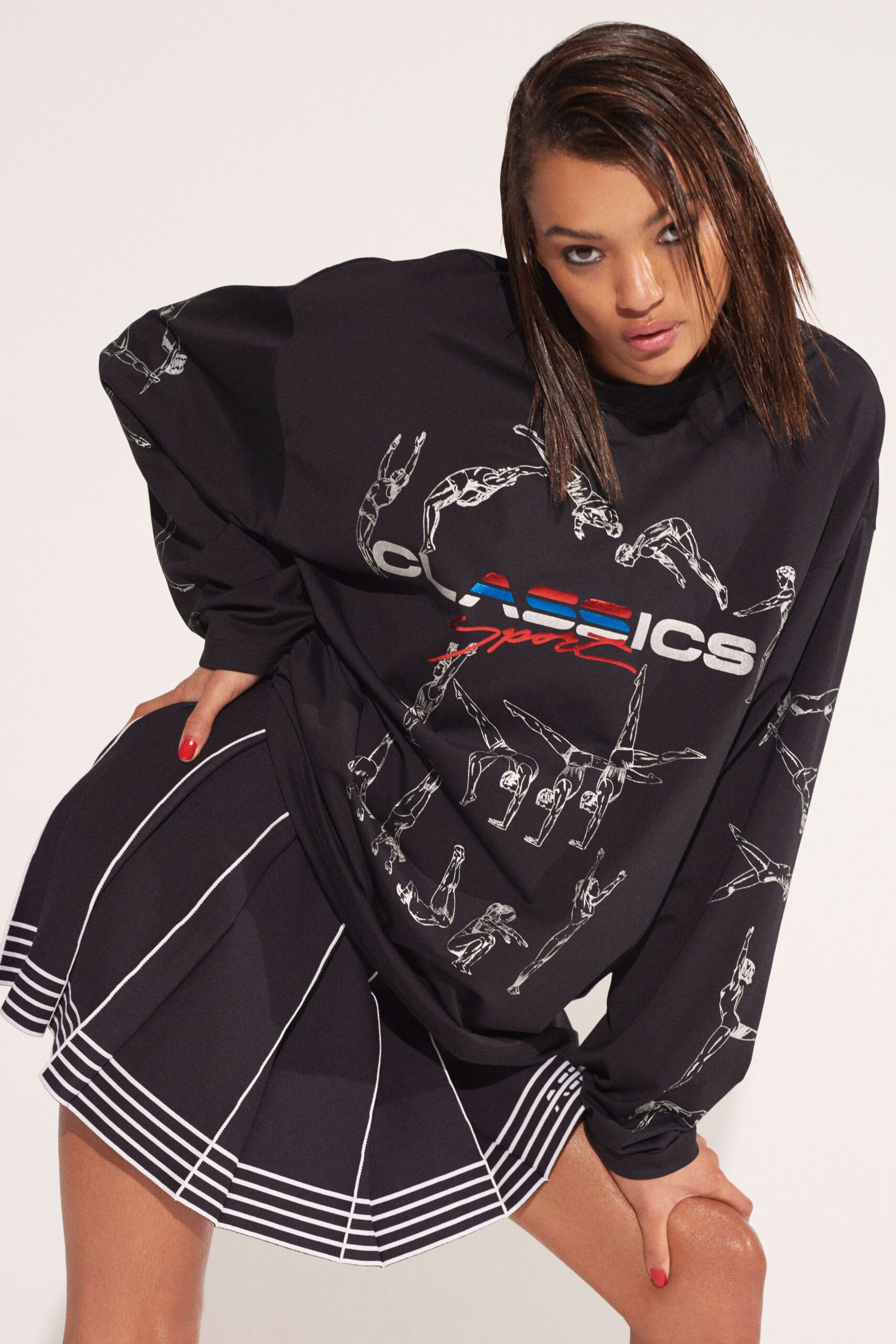 black oversized top and pleated mini skirt