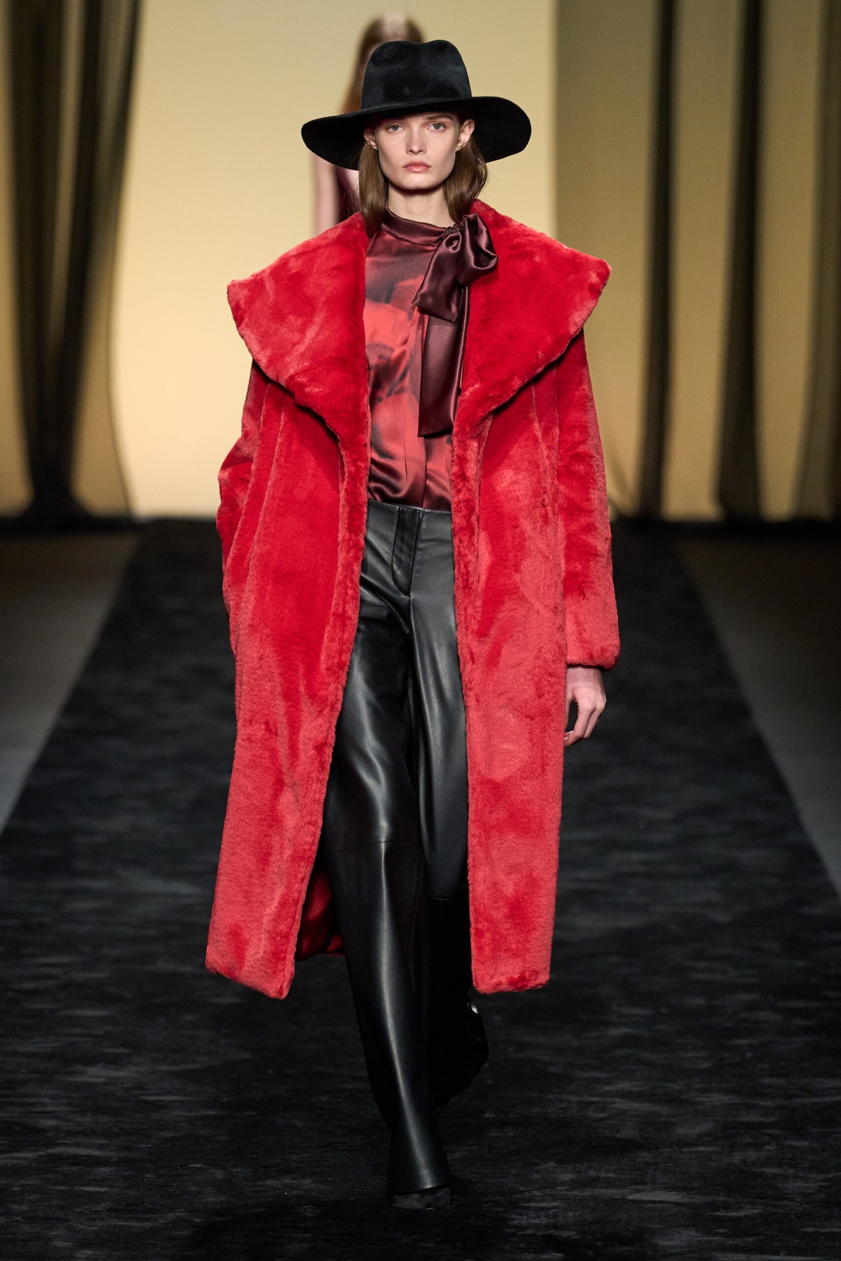 red faux-fur coat with black leather pants