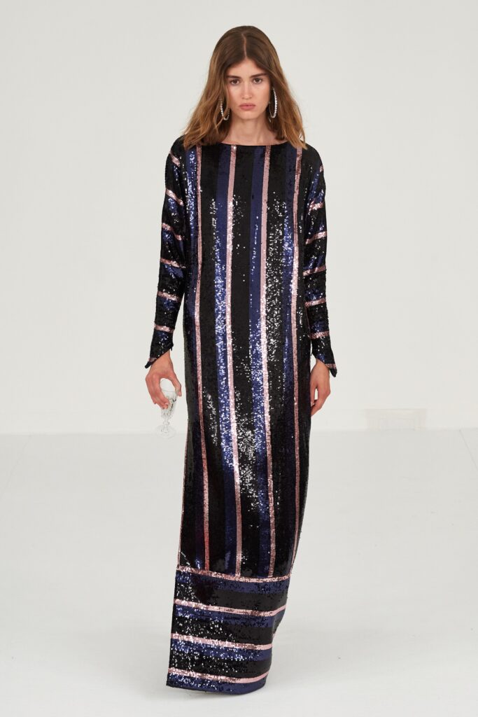 A fitted long-sleeve dress in black and purple with a high neckline and striped sequin design.