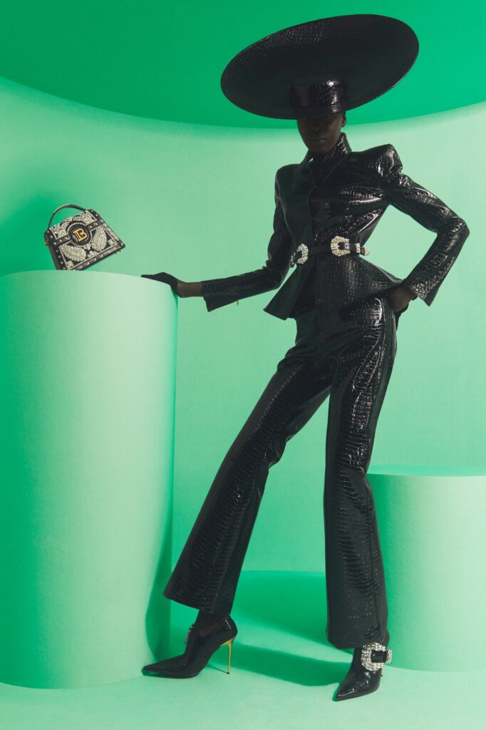 A fitted black leather suit with a collared long-sleeve design and flared trousers.