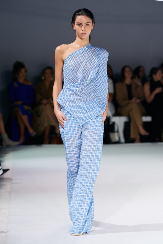 A relaxed blue checked sleeveless top paired with matching pants for a stylish look.