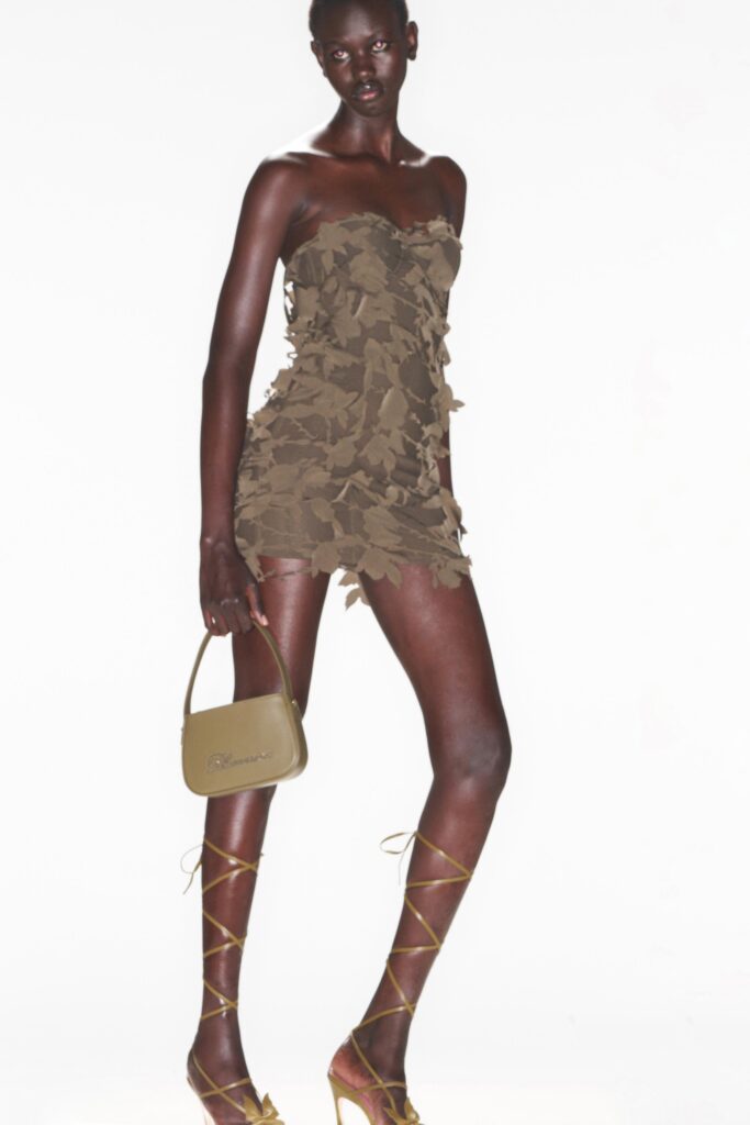 A fitted brown strapless dress with a ruffled design, perfect for a stylish evening look.