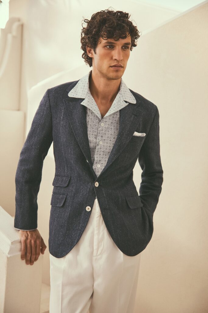A tailored blue blazer paired with a printed white shirt, perfect for a stylish look.