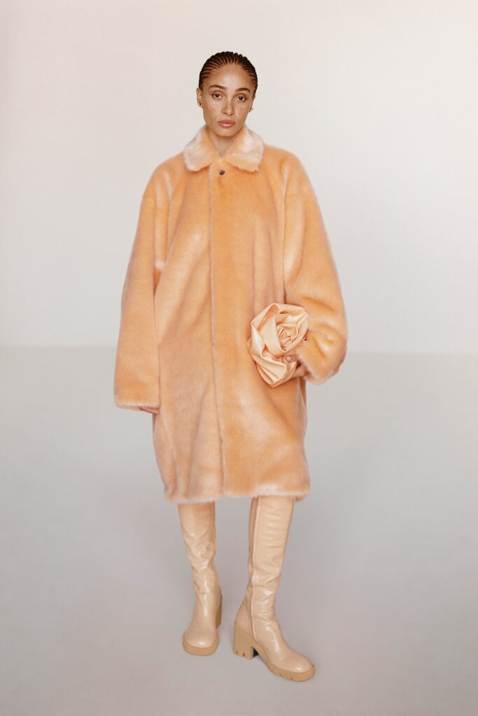 An oversized orange fur coat with long sleeves and a collared design.