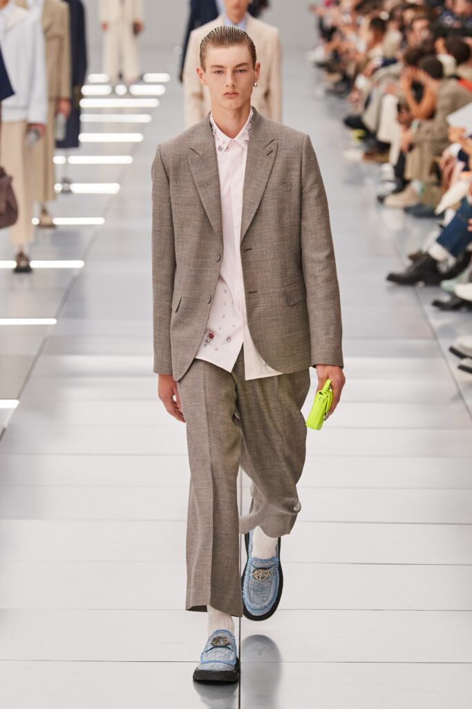 A tailored gray suit with a long-sleeve collared shirt and buttoned details.