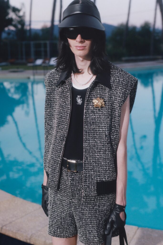 A relaxed fit black and white tweed sleeveless jacket paired with matching shorts.